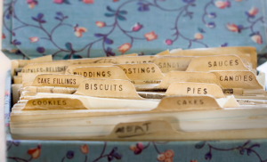 Close-up of a well-worn recipe box with aged recipe cards, representing the preservation of family recipes in a legacy cookbook.