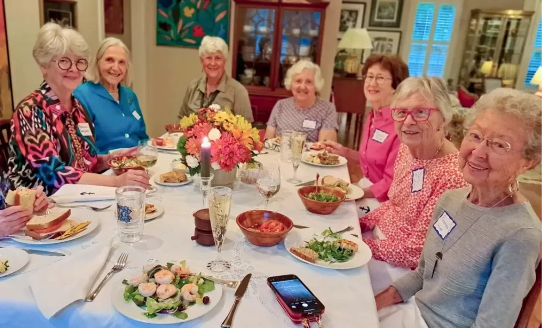 Residents sharing a meal and conversation, highlighting the sense of connection and well‑being in the community.