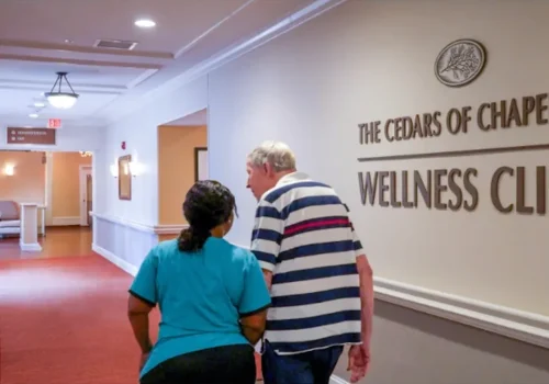 Nurse and patient walking down hall